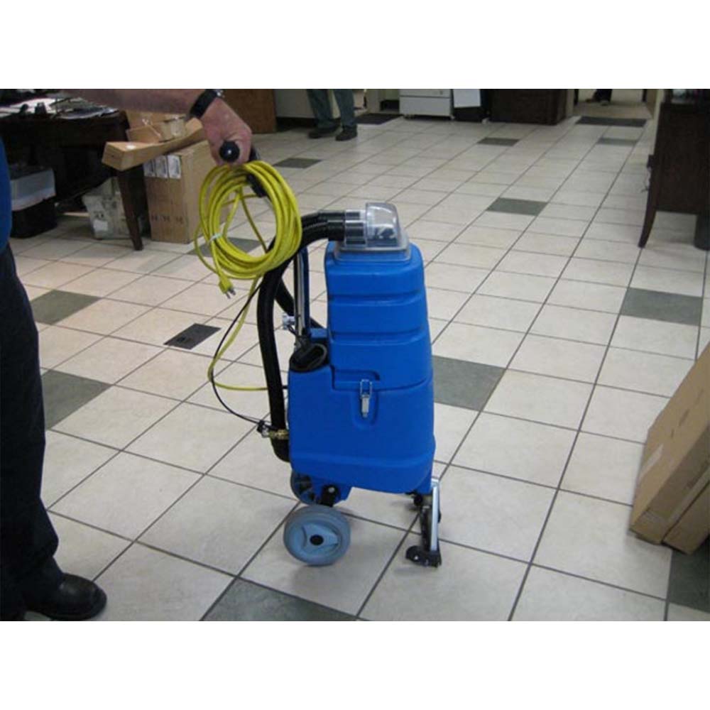 Worker using Nacecare AV 4X Carpet Spot Extractor to clean the floor.