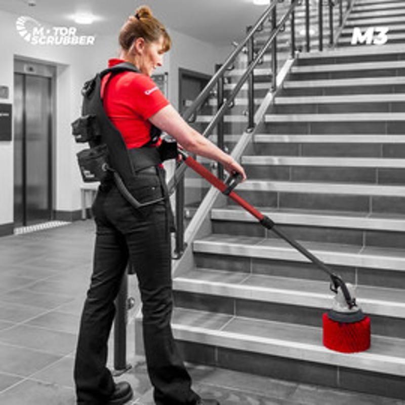 Motor Scrubber M3 Backpack Floor Scrubber being used by worker on stairs for efficient cleaning